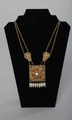 Collier 1950 avec 1 plaque en guilloché doré incrustée de strass et pendeloques de perles