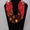 Gros collier en perles de verre orange et bordeaux