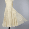 Robe 1950 en organdi jaune et motifs blanc floqués