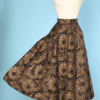 Jupe 1950 en faille noire imprimé de motifs brodés de paillettes