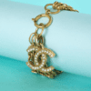 B7775-Bracelet-couture-Chanel-metal-dore-strass-et-double-C-001